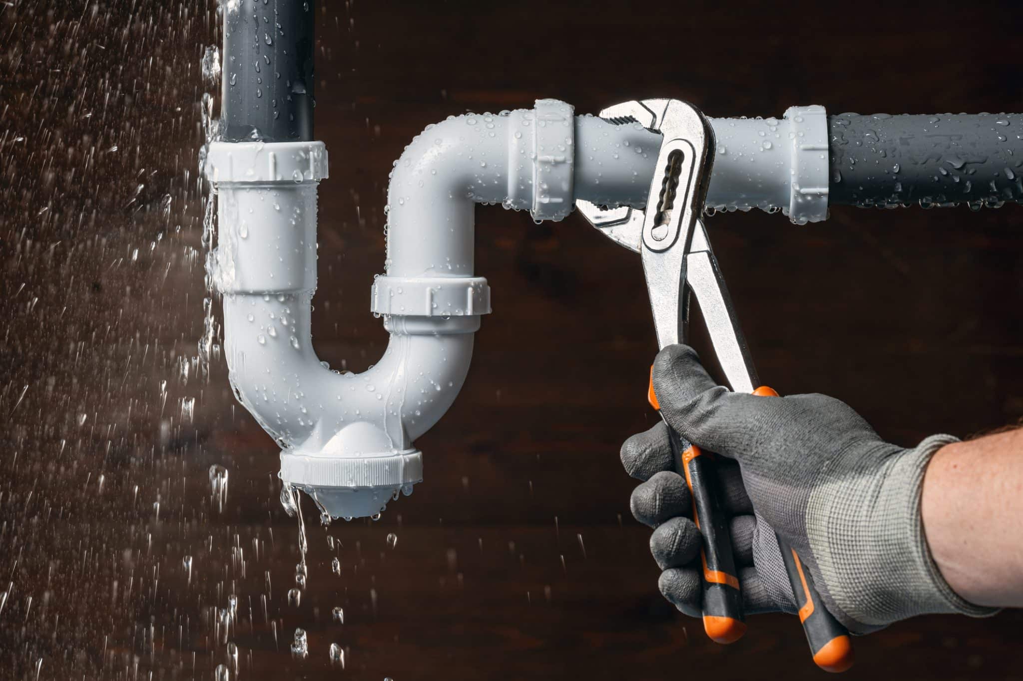 a leaky pipe being replaced by a plumbers wrench