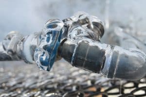 a close-up of a frozen pipe from winter weather hitting a Tacoma home.