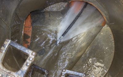 a sewer drain being cleaned by a hydro jet head