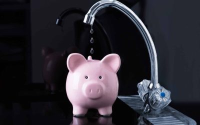 Water leak falling into a piggy bank showing money wasted