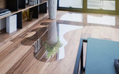 A water leak spreading across the wood floor of a home.